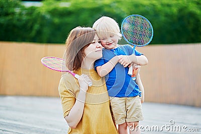 Little boy playing badminton with mom on the playground Stock Photo