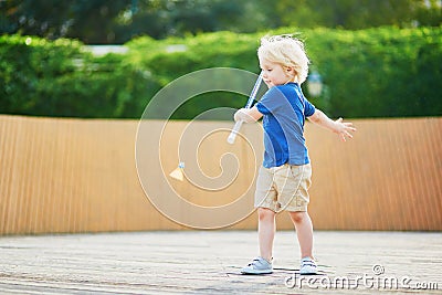 Little boy playing badminton on the playground Stock Photo