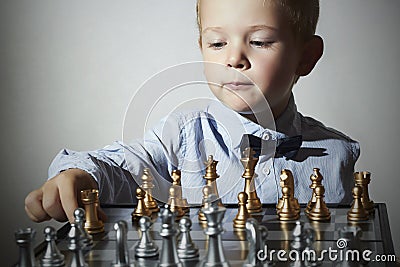 Little boy playing chess.Smart kid.Little genius Child. Intelligent gam Stock Photo