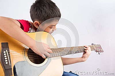 Little boy playing classic guitar course on white background Stock Photo