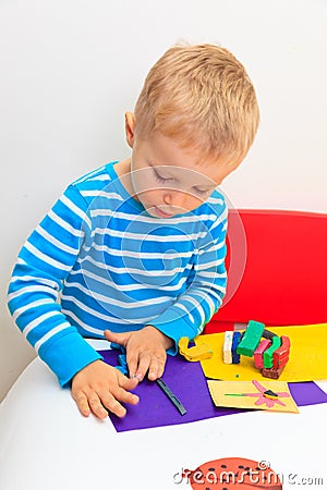 Little boy playing with clay dough Stock Photo