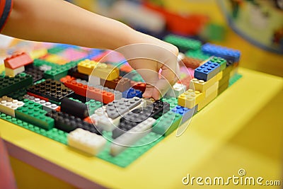Little boy playing plastic blocks construction indoor Stock Photo
