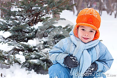 Little boy playing snowballs; Stock Photo