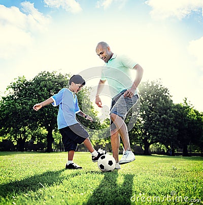 Little Boy Playing Soccer With His Father Concept Stock Photo