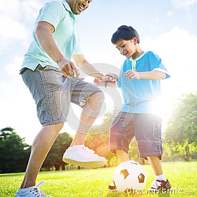 Little Boy Playing Soccer With His Father Concept Stock Photo