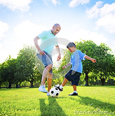 Little Boy Playing Soccer With His Father Concept Stock Photo