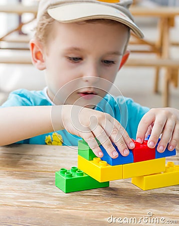 Little boy plays with plastic blocks Stock Photo