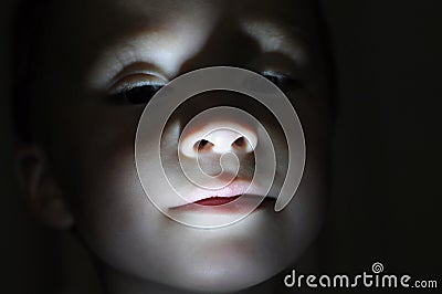 Little boy portrait in the dark making horror Stock Photo