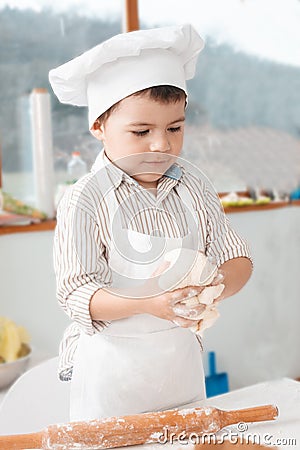Little boy preparing dough Stock Photo