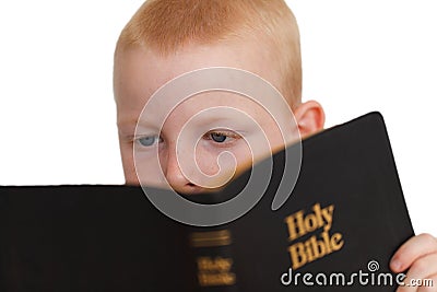 Little boy reading Holy Bible Stock Photo