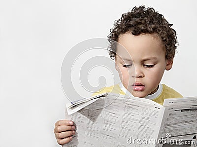 Little boy reading newspaper stock photo Stock Photo