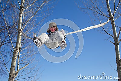 A little boy is riding a rope swing Stock Photo