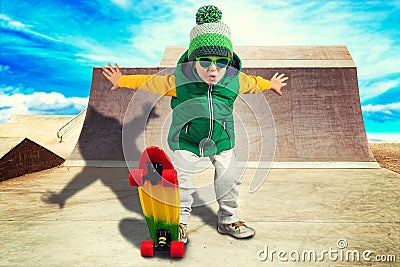 Little boy riding on steep hills to skateboard at the skate Park.Extreme sports. Stock Photo