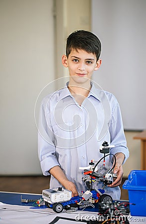 Little boy in robotics school makes robot Stock Photo