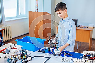 Little boy in robotics school makes robot Stock Photo