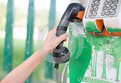 Little boy's hand using public phone outdoor emergency Stock Photo