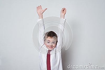 Little boy in shirt and tie raised his hands up. Middle School, Junior High School Stock Photo