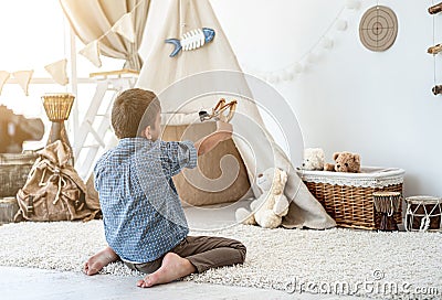 Little boy shooting target with slingshot Stock Photo
