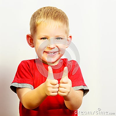 Little boy showing thumb up success hand sign gesture. Stock Photo