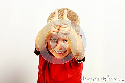 Little boy showing thumb up success hand sign gesture. Stock Photo