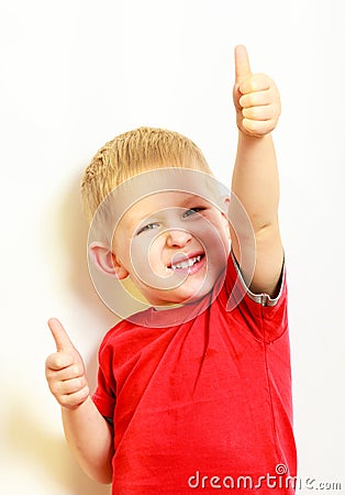 Little boy showing thumb up success hand sign gesture. Stock Photo