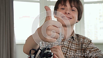 Little boy shows his thumb up with toy vehicle Stock Photo