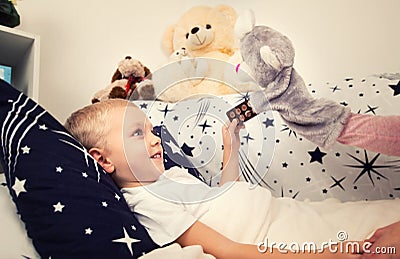 The little boy is sick, lies on the bed. The child is sick Stock Photo