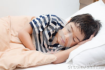 Little boy sleeping on bed Stock Photo