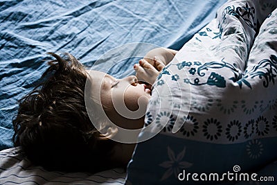 Little boy sleeping in bed Stock Photo