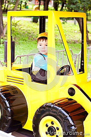 Little boy smiling and playing in the toy car Stock Photo