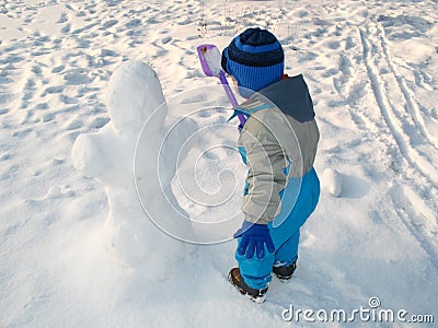 Little boy and snowman Stock Photo