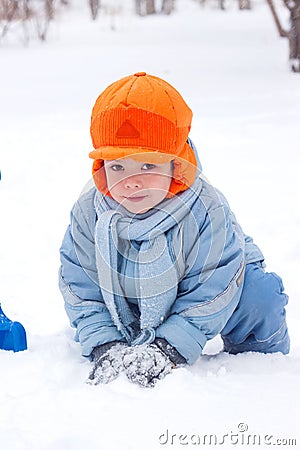 Little boy snowman sculpts Stock Photo