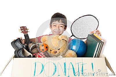 Little boy taking Donation box full with stuff for donate Stock Photo
