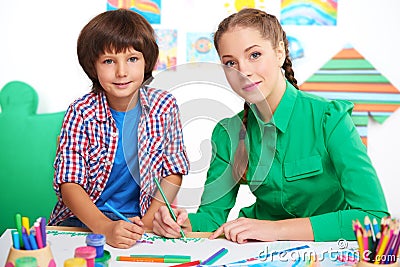 Little boy and teacher drawing in a preschool Stock Photo