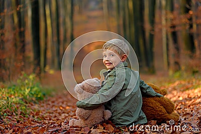 A little boy playing in the autumn park. Stock Photo