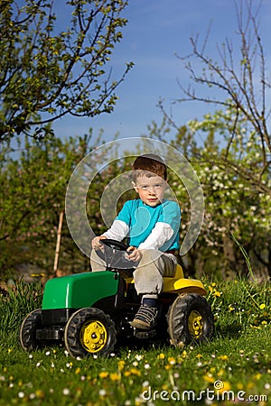 Little boy and tractor. Stock Photo