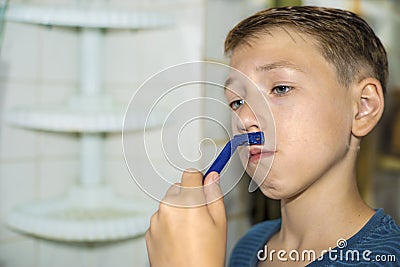 A little boy tries to shave and does not know how Stock Photo