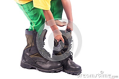 Little boy try wearing big shoe Stock Photo