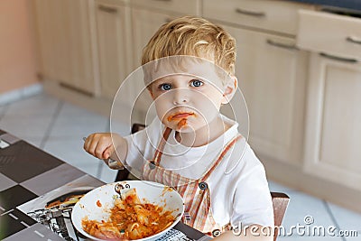 Little boy two years old eating pasta Stock Photo