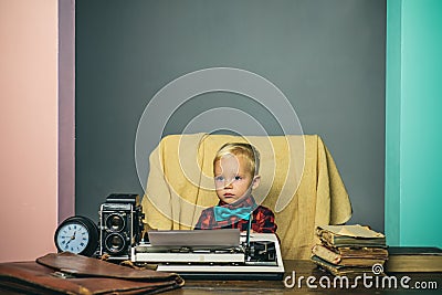 Little boy type research paper on typewriter. Child typewrite research work at desk Stock Photo