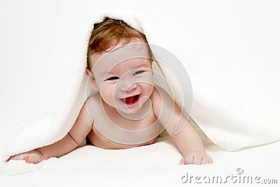 Little boy under a terry towel Stock Photo