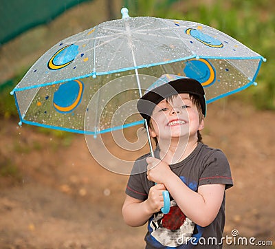 Little boy under umbrella Stock Photo
