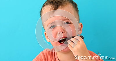 Little boy is upset eating chocolate Stock Photo
