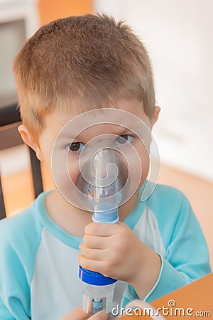 Little boy using nebulizer during inhaling therapy. Stock Photo