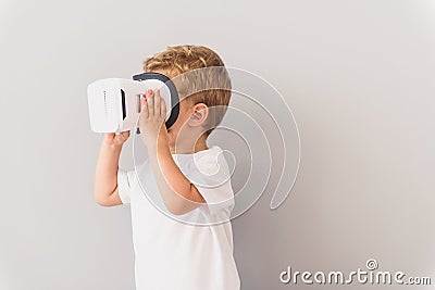 Little boy using virtual reality device in studio Stock Photo