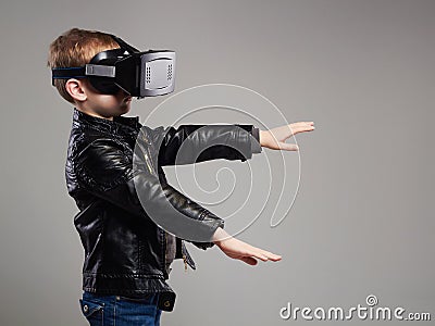 Little Boy in virtual reality glasses playing the game Stock Photo