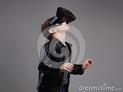 Little Boy in virtual reality glasses playing the game. kids fun Stock Photo