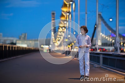 Little boy walking alone scared on bridge in dark Stock Photo