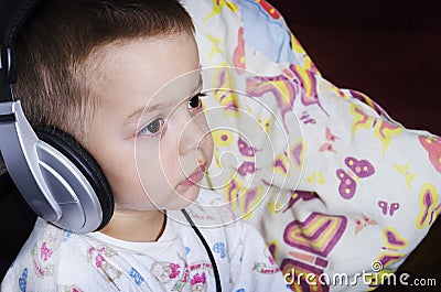 Little boy watching cartoons before bedtime Stock Photo