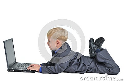 Little boy wearing suit working on laptop Stock Photo